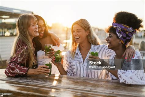 Happy Girls Having Fun Drinking Cocktails At Bar On The Beach Soft Focus On Center Girl Face