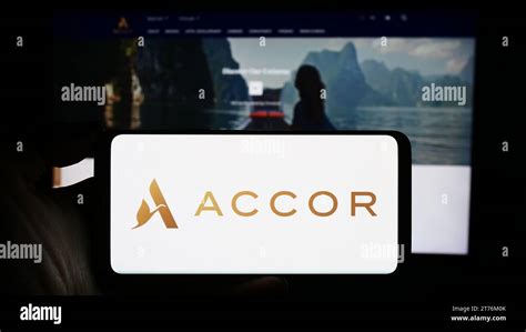 Person Holding Smartphone With Logo Of French Hospitality Company Accor