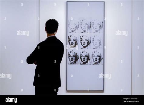 A Man Inspects Andy Warhol S Nine Marilyns On Display At Sotheby S