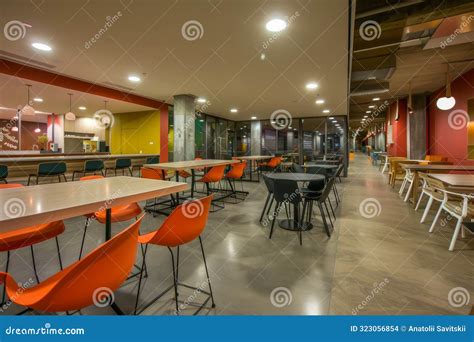 A Modern Student Lounge With Dining Tables And Chairs Perfect For