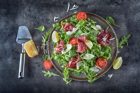 Dried beef bresaola. Salad bresaola arugula baby spinach tomatoes lime ...