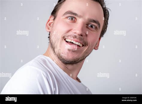 Handsome Brunette Guy With Bristles In A White T Shirt Makes Funny