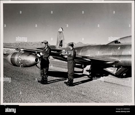 Airmen checking plane, Indian Springs, Nevada, April 20, 1952, by the ...