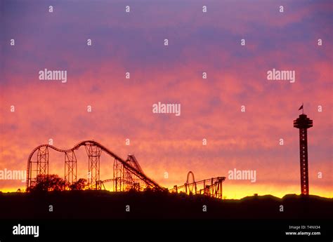 California,Southern California,Pacific,Santa Clarita,roller coaster silhouetted against sunset ...