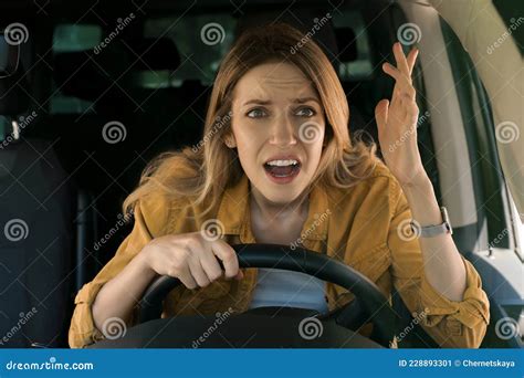 Stressed Angry Woman In Driver`s Seat Of Modern Car View Through