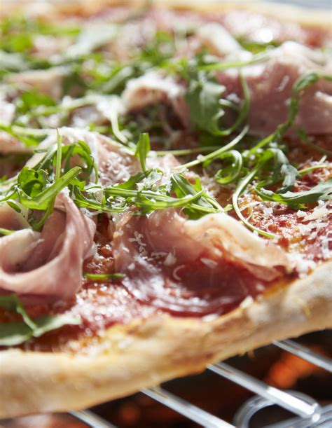 Pizza Topped With Prosciutto And Rocket Kiss The Cook Catering