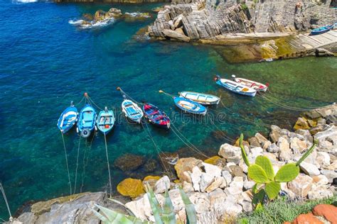 Fishing Boats Floating In The Harbour Of Cinque Terre Stock Photo