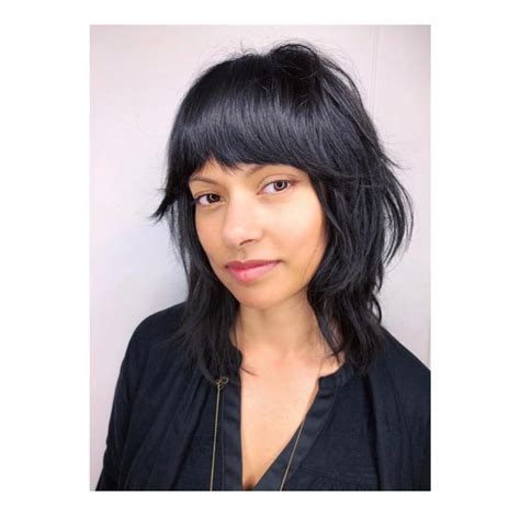 Black Shaggy Razor Cut Bob With Full Fringe Bangs And Undone Texture The Latest Hairstyles For