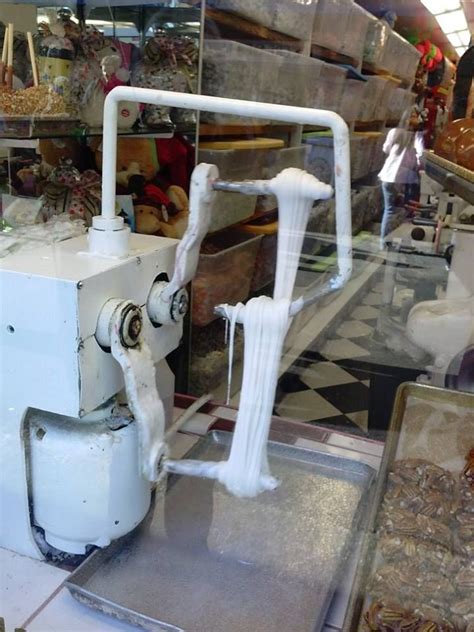 The saltwater taffy pulling machine in the window of the Carousel Candy Shop on Fisherman's ...