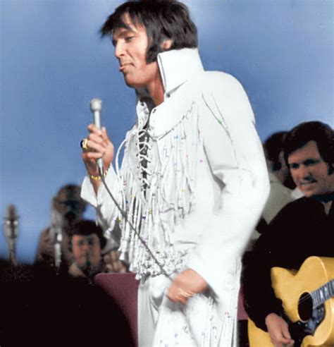 Elvis Presley Is Pictured Performing In The White Beaded Fringe Suit On Stage At The