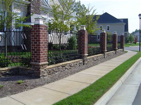 Brick, Stacked Stone and Wrought-Iron Patterned Fence with Light Caps - IDF Pensign