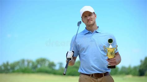 Confident Golf Player with Gold Cup and Club Smiling on Camera, Sport ...