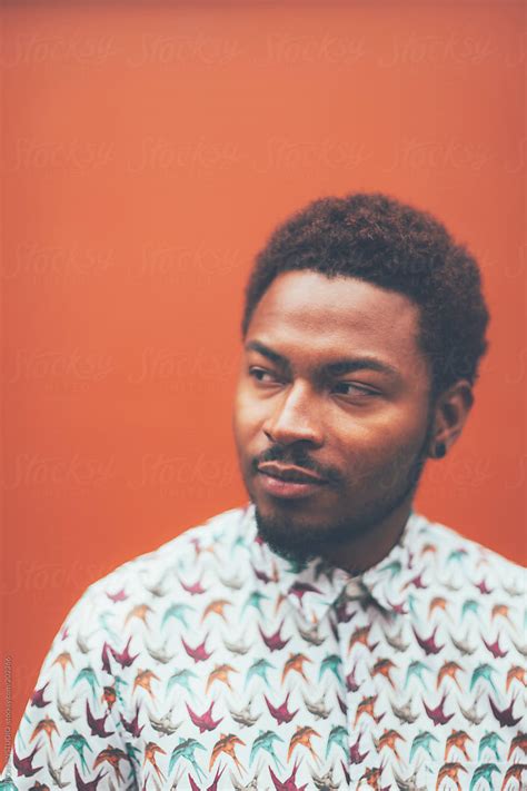 Portrait Of Modern Young Black Man In Front A Orange Wall By Stocksy