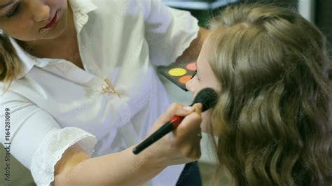 Professional Makeup Artist Applying Tonal Powder To Blond Models Skin