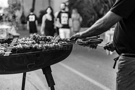 Man Roasting Meat Skewers On The Street During A Folk Festival In Italy