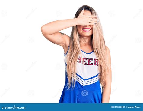 Young Beautiful Blonde Woman Wearing Cheerleader Uniform Smiling And