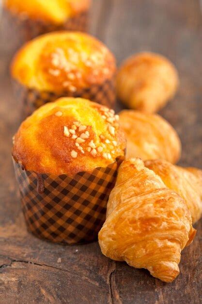 Premium Photo Close Up Of Croissant And Muffin On Table