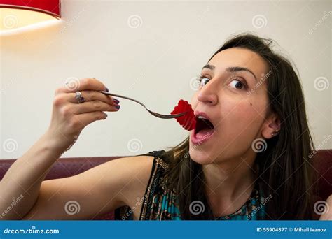 Girl Making A Funny Face Holding A Fork With Food Looking At The