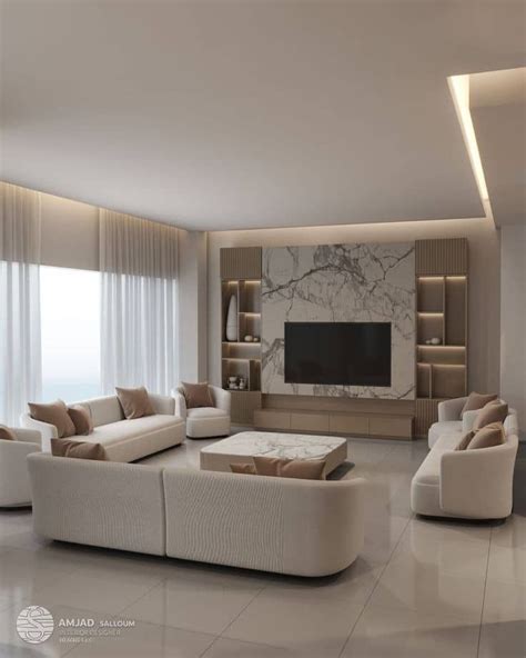 A Living Room Filled With White Furniture And A Flat Screen Tv Mounted