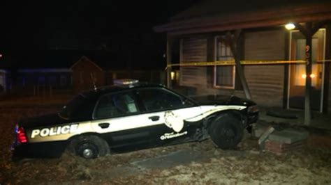 Greensboro police car slams into home