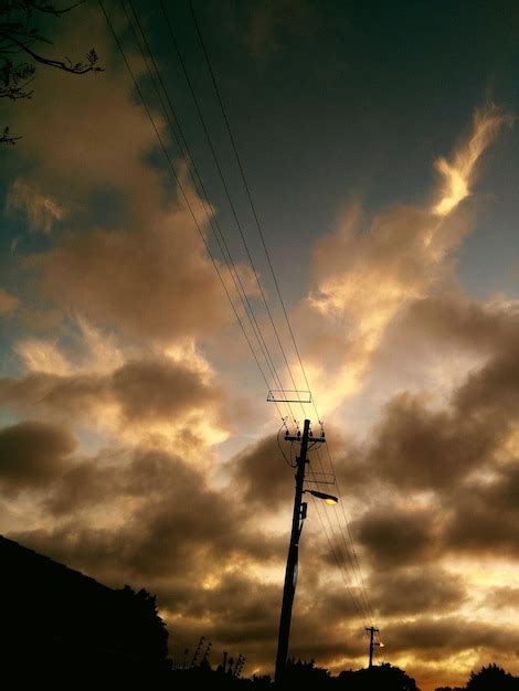 Premium Photo Low Angle View Of Silhouette Cranes Against Dramatic Sky