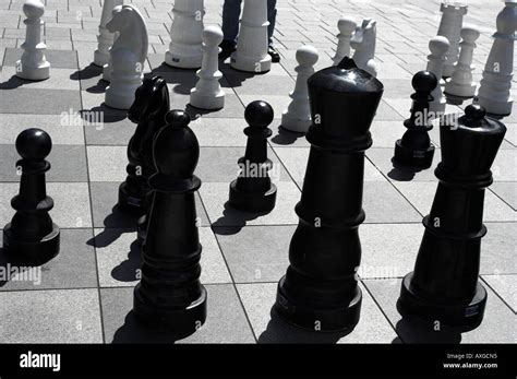 Giant Black And White Chess Peices On A City Centre Outdoors Chessboard