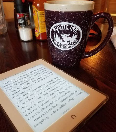 A Tablet Sitting On Top Of A Wooden Table Next To A Coffee Mug