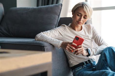 Smiling Mid Aged Blonde Woman Using Mobile Phone Stock Photo Image Of