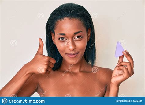 Young African American Woman Holding Makeup Sponge Smiling Happy And