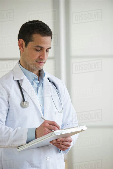 Doctor Writing In Notepad Stock Photo Dissolve