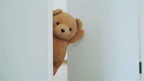 Kid A Brown Teddy Bear Poked His Face From Behind The Wall The Brown