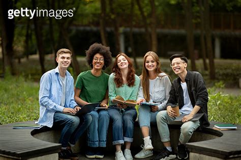 Group Of Happy Multiracial High School Students Sitting Together On