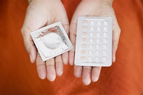 Premium Photo Woman Is Using Birth Control Pills And Condoms Before Having Sex With Your