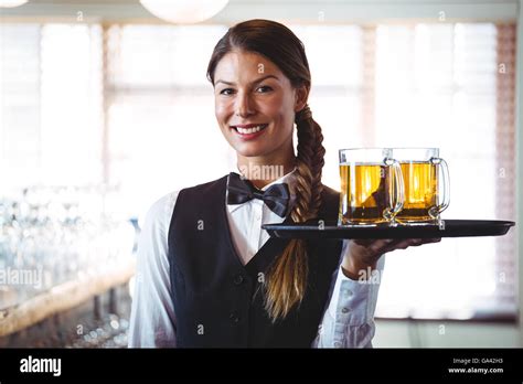 Waitress Holding Beers Stock Photo Alamy