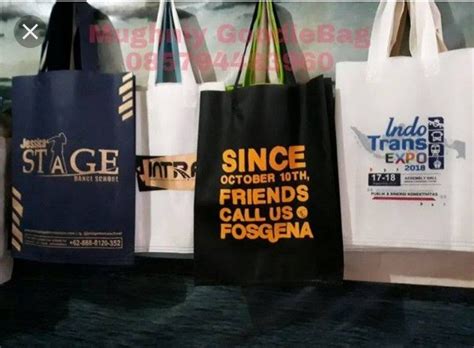 Several Shopping Bags Are Hanging On A Wall