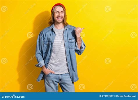 Photo Of Friendly Guy With Long Hairdo Dressed Jeans Shirt Look Directing Empty Space Hand In