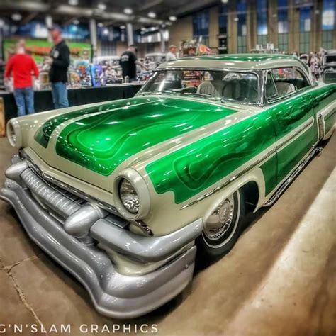 a green and white car is on display