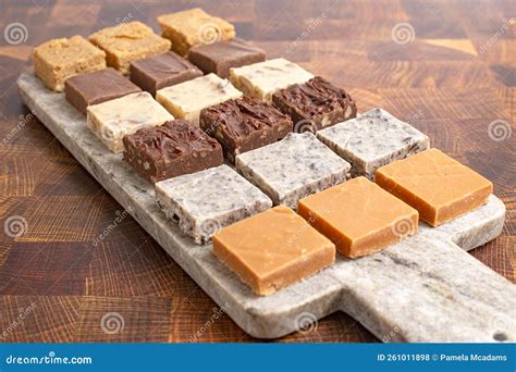 An Assortment Of Various Flavors Of Fudge On A Wood Butcher Block Stock