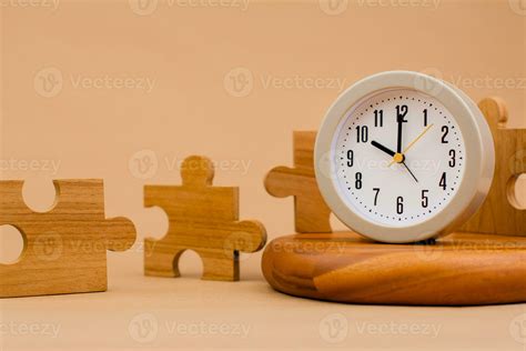 Clock and jigsaw puzzle pieces. Time lapse time. Wooden jigsaw puzzle ...