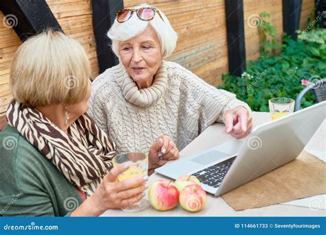 Two Senior Women Using Laptop Outdoors Stock Image Image Of Modern