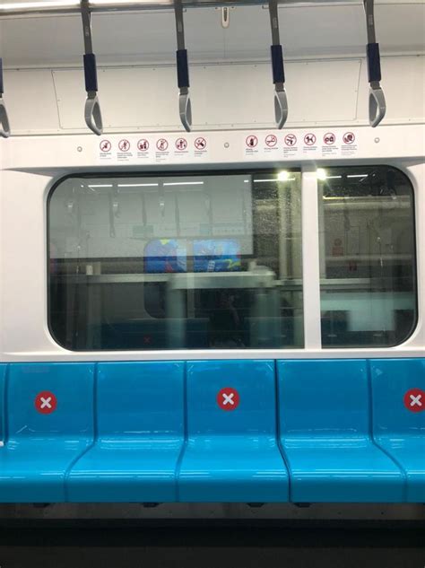 A Blue And White Subway Car With Red Cross Marks On It S Seat Area