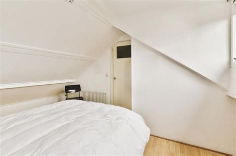 Premium Photo | A bedroom with a white bed and a white wall