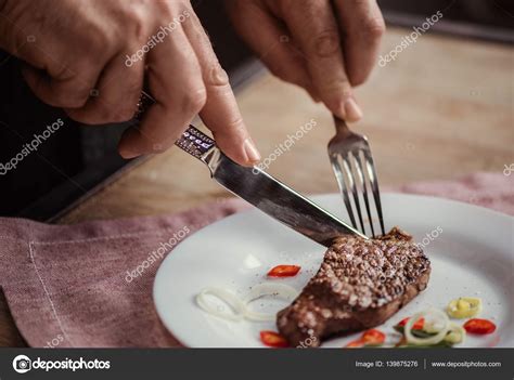 Man eating steak — Stock Photo © ArturVerkhovetskiy #139875276