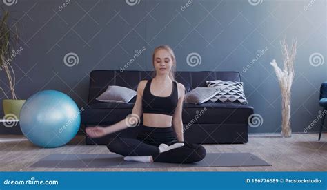 Flexible Girl Stretching Her Body Sitting In Lotus Position Stock