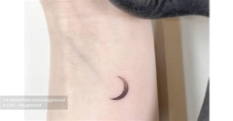 Crescent moon tattoo done on the wrist, minimalistic