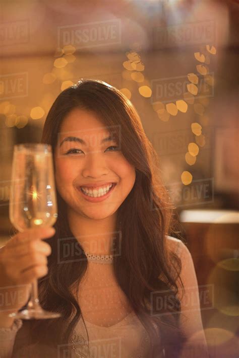 Portrait Smiling Chinese Woman Toasting Champagne Flute Stock Photo