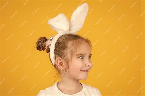 Premium Photo Happy Small Easter Girl In Bunny Ears On Yellow Background