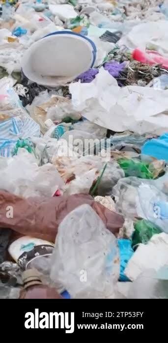 The Beach Is Littered With Empty Dirty Plastic Bottles And Various