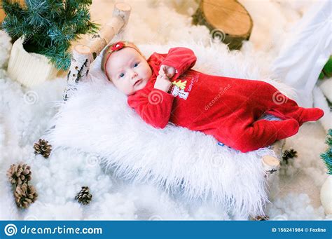 Cute Newborn Baby In A Christmas Costume On A Wooden Bed Stock Photo