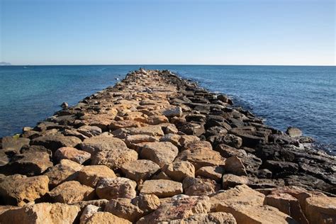 Premium Photo Rock Breakwater And Sea In El Campello Alicante Spain